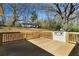 Large wooden back deck with built-in outdoor grill and views of the tree-lined backyard at 2215 Gordon Se Cir, Smyrna, GA 30080