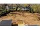 Aerial view of the backyard featuring a back deck with stairs and lush landscaping at 2215 Gordon Se Cir, Smyrna, GA 30080