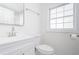 Modern bathroom with sleek white vanity, toilet, and contemporary fixtures at 2215 Gordon Se Cir, Smyrna, GA 30080
