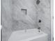 Elegant bathroom with a tub featuring stylish gray tiling at 2215 Gordon Se Cir, Smyrna, GA 30080
