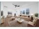 Bright, staged living room with a modern ceiling fan, hardwood floors, and plenty of natural light at 2215 Gordon Se Cir, Smyrna, GA 30080