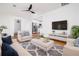 Bright living room showcasing hardwood floors, a ceiling fan, and an open transition to the kitchen at 2215 Gordon Se Cir, Smyrna, GA 30080