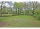Large backyard is fenced in and surrounded by mature trees at 5164 Phillips Dr, Forest Park, GA 30297