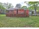 Home's backyard shows the large deck and stairs leading down to the yard at 5164 Phillips Dr, Forest Park, GA 30297