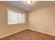 Cozy bedroom with wood flooring and a large window for natural light at 5164 Phillips Dr, Forest Park, GA 30297