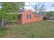 Side view of home with carport, fenced yard and well-maintained lawn at 5164 Phillips Dr, Forest Park, GA 30297