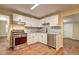 Modern kitchen featuring white cabinetry, stainless steel appliances and grey backsplash at 5164 Phillips Dr, Forest Park, GA 30297