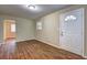 Living room featuring hardwood floors and a white front door with half moon window at 5164 Phillips Dr, Forest Park, GA 30297