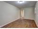 Spacious living room with neutral walls and wood-look floors and a view to another room at 5164 Phillips Dr, Forest Park, GA 30297