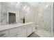 Lavish bathroom featuring marble walls, floors and a dual sink vanity at 6090 Pennant Ln, Suwanee, GA 30024