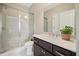 Bathroom featuring glass-enclosed shower, dark wood vanity with white countertop and vessel sink at 6090 Pennant Ln, Suwanee, GA 30024