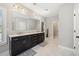 Bright bathroom with dual vanity, ample storage and marble floors at 6090 Pennant Ln, Suwanee, GA 30024