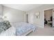 Bedroom with plush carpet, walk-in closet and comfortable queen-sized bed at 6090 Pennant Ln, Suwanee, GA 30024