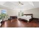Spacious bedroom with hardwood floors and modern furniture at 6090 Pennant Ln, Suwanee, GA 30024