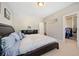 Comfortable bedroom featuring a walk-in closet and modern furnishings at 6090 Pennant Ln, Suwanee, GA 30024