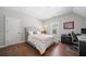 Cozy bedroom with hardwood floors and natural light from the window at 6090 Pennant Ln, Suwanee, GA 30024