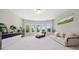 Bonus room with bay windows, plush carpet and comfortable seating at 6090 Pennant Ln, Suwanee, GA 30024