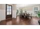 Formal dining area featuring dark hardwood floors, wainscoting, and an elegant chandelier at 6090 Pennant Ln, Suwanee, GA 30024