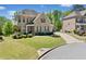 Charming brick home featuring lush landscaping and a curved driveway, perfect for curb appeal at 6090 Pennant Ln, Suwanee, GA 30024