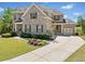 Lovely brick residence with a well-maintained lawn, charming landscaping, and a paved driveway at 6090 Pennant Ln, Suwanee, GA 30024