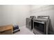 Modern laundry room featuring stainless steel appliances, wire shelving, and wicker basket at 6090 Pennant Ln, Suwanee, GA 30024