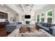 Stylish living room with coffered ceilings, large windows, a fireplace, and built in shelves at 6090 Pennant Ln, Suwanee, GA 30024