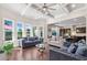 Spacious living room featuring a coffered ceiling, hardwood floors, and ample natural light at 6090 Pennant Ln, Suwanee, GA 30024