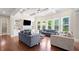 Bright living room with hardwood floors, coffered ceilings, built-ins, a fireplace, and large windows offering scenic views at 6090 Pennant Ln, Suwanee, GA 30024