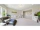 Spacious living room with modern decor, large windows and stylish seating arrangements at 6090 Pennant Ln, Suwanee, GA 30024