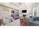Cozy living room featuring a fireplace, built-in shelves, and hardwood floors, perfect for relaxation at 6090 Pennant Ln, Suwanee, GA 30024