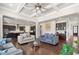 Open-concept living area seamlessly connecting to the kitchen, enhanced by coffered ceilings and ample natural light at 6090 Pennant Ln, Suwanee, GA 30024
