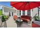 Outdoor patio furnished with wicker seating and umbrella at 6090 Pennant Ln, Suwanee, GA 30024