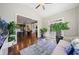 Open sunroom showcasing hardwood floors, a comfortable sitting area, and seamless access to the kitchen and living room at 6090 Pennant Ln, Suwanee, GA 30024
