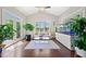 Bright sunroom with hardwood floors, large windows, and plenty of natural light, creating a peaceful atmosphere at 6090 Pennant Ln, Suwanee, GA 30024
