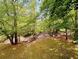 Picturesque backyard with a gentle creek flowing through, surrounded by mature trees and natural vegetation at 921 Hemingway Rd, Stone Mountain, GA 30088