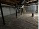 Spacious encapsulated basement featuring a moisture barrier and exposed beams, perfect for storage or future finishing at 921 Hemingway Rd, Stone Mountain, GA 30088