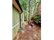 Exterior side shot featuring a rock bed flower garden, trees, and blue stepping stones along the side of the home at 921 Hemingway Rd, Stone Mountain, GA 30088