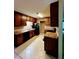 Kitchen featuring tile floors, wood cabinets, and black appliances at 921 Hemingway Rd, Stone Mountain, GA 30088