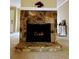 Living room with a stone fireplace and light carpet at 921 Hemingway Rd, Stone Mountain, GA 30088