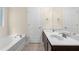 Bathroom featuring a large soaking tub, double sink vanity, and a walk-in shower at 1067 Brittania Rd, Stone Mountain, GA 30083