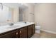 Bathroom with double vanity, dark cabinets, a large mirror, a shower, and a toilet at 1067 Brittania Rd, Stone Mountain, GA 30083