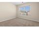 Bedroom with carpet and window overlooking the street and neighborhood at 1067 Brittania Rd, Stone Mountain, GA 30083