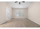 Spacious bedroom with neutral carpet, paint, a ceiling fan, and natural light from a window at 1067 Brittania Rd, Stone Mountain, GA 30083