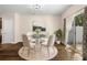 Dining room features a modern chandelier, glass table, and sliding door at 1067 Brittania Rd, Stone Mountain, GA 30083