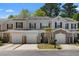 Charming townhome featuring attached garages, beautiful landscaping and inviting front entrances at 1067 Brittania Rd, Stone Mountain, GA 30083