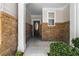Inviting front porch featuring brick accents, columns and a stylish front door at 1067 Brittania Rd, Stone Mountain, GA 30083