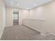 Hallway with neutral carpet, paint, and a view into another room with bright natural light at 1067 Brittania Rd, Stone Mountain, GA 30083