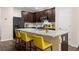 Modern kitchen island with marble countertops, bar seating, and stainless steel appliances at 1067 Brittania Rd, Stone Mountain, GA 30083