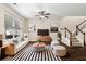Bright living room with large window, ceiling fan, and staircase at 1067 Brittania Rd, Stone Mountain, GA 30083