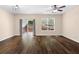 Open-concept living room featuring hardwood floors, a sliding glass door and neutral walls at 1067 Brittania Rd, Stone Mountain, GA 30083